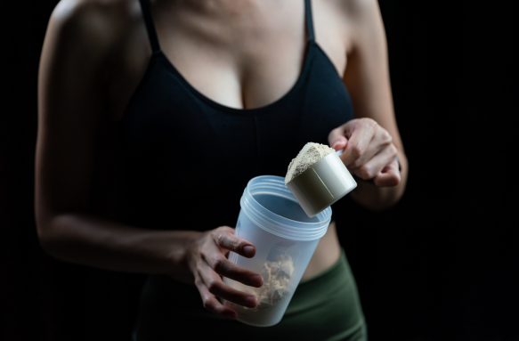 An image showcasing a girl with protein powder and a shaker