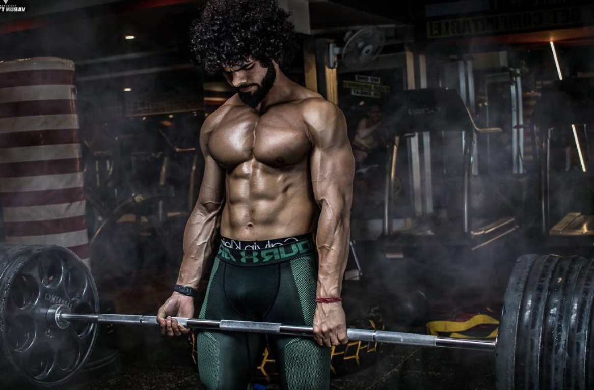 An image of a bodybuilder man lifting weights